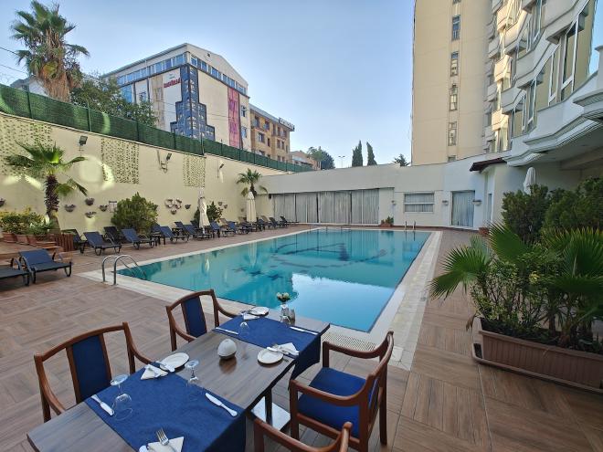 Breakfast tables set out by the pool at the Akgün Hotel.