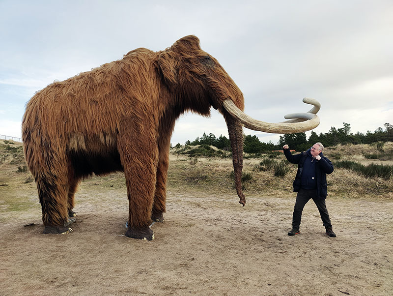 Kristian with a life-sized woolly mammoth