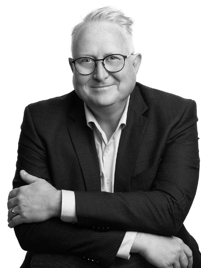 Black-and-white portrait of Kristian Stoffregen with arms crossed